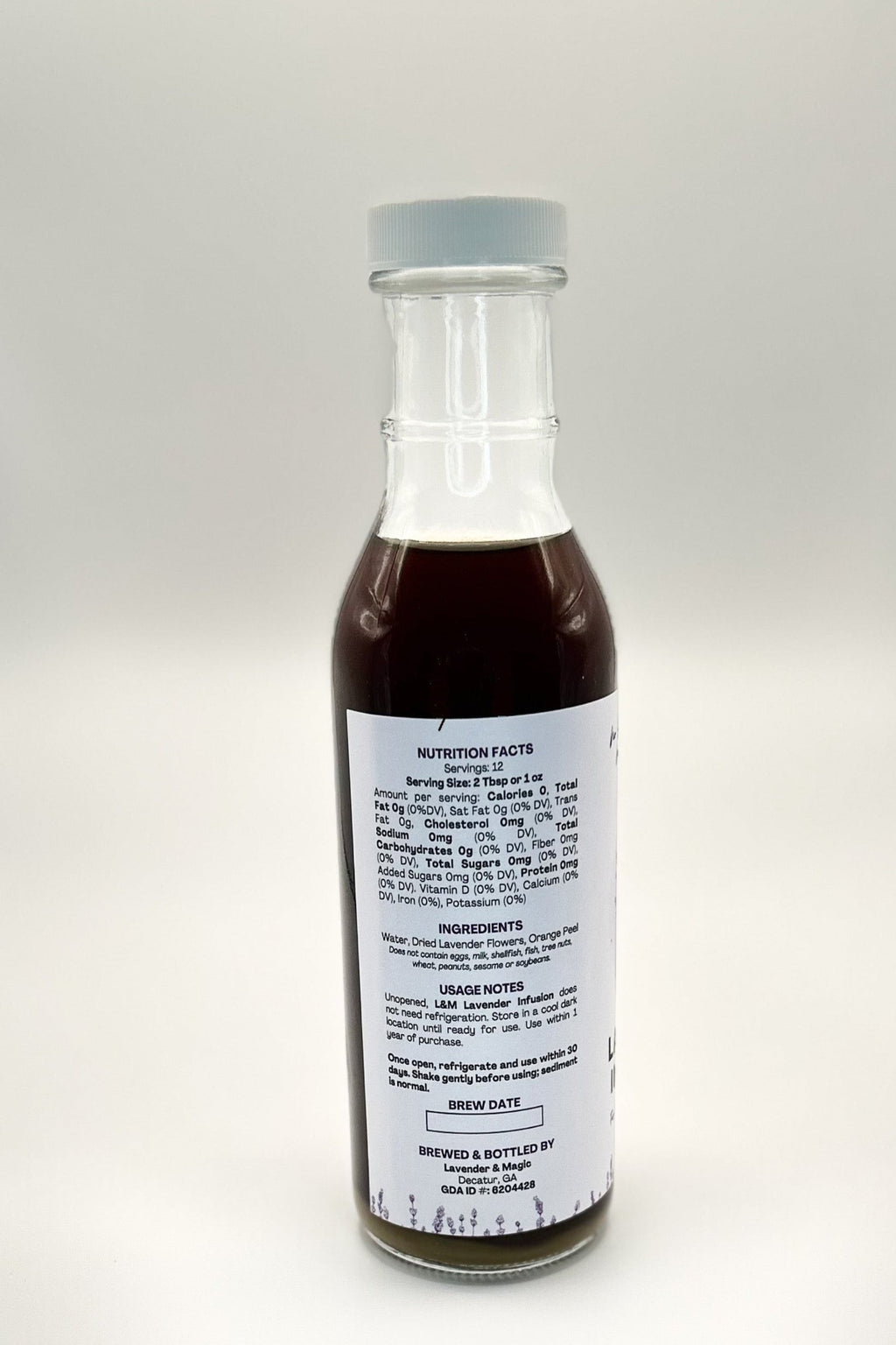 Bottle of lavender infusion with a label on a white background